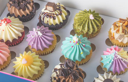 Many colorful cupcakes present in box set for celebrationの写真素材