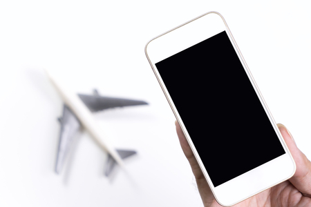 Empty Mobile smartphone with airplane for Online travel agency concept mock upの写真素材