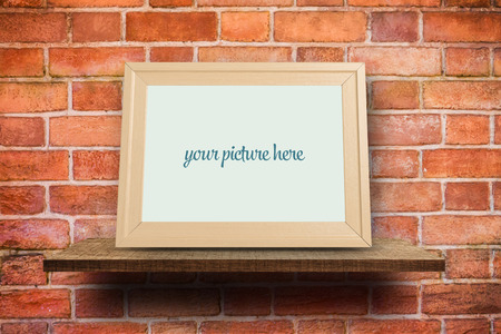 Blank photo frame on Red brick wallの写真素材