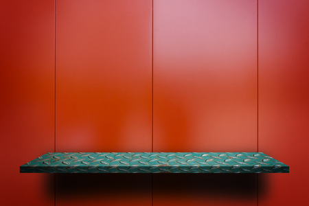 Green Metal counter on Shiny red metal backgroundの写真素材