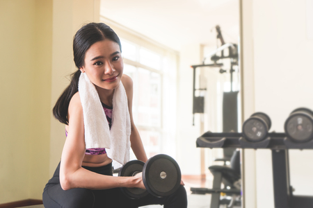 Great shaped woman is working out alone in fitnessの写真素材