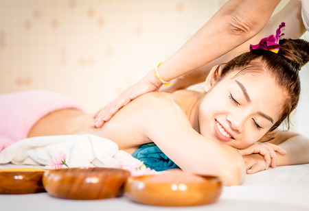 Happy Woman is getting her back scrub in Thai Spa skin treatmentの写真素材