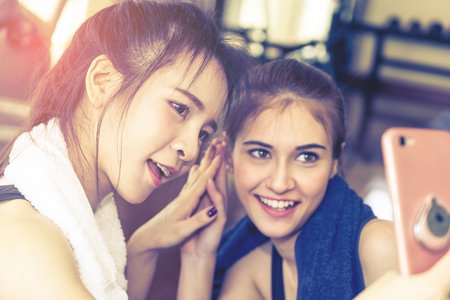 Girl friends is taking selfie and having happy time in Fitness work out gymの写真素材