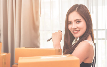 Beautiful woman is managing her product delivery for her online business