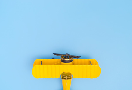 Yellow Metal plane on blue copy space on the top for travel conceptの写真素材