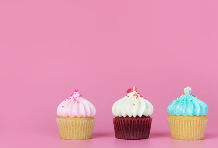 Three mini fancy cupcake on pink copy space backgroundの写真素材