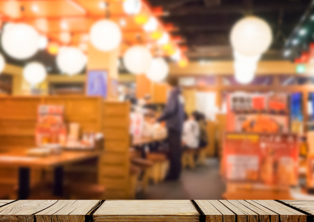 Empty wooden shelf display with Izakaya japanese restaurant backgroundの写真素材