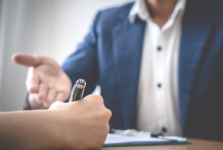 Business man hand is inviting partner to sign the agreement business dealの写真素材