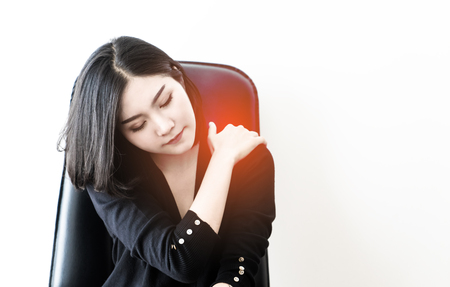 Chinese woman is suffering from office syndrome injury on her shoulderの写真素材