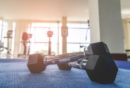 Pair of Small dumbbell on fitness gym floorの写真素材