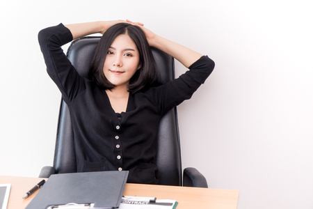 Pretty business woman relaxing and sitting in office chairの写真素材