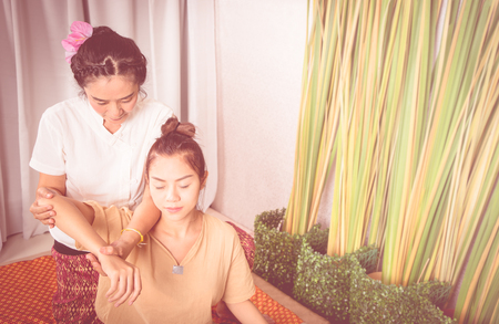 Woman is getting arm massage in Thai massage spaの写真素材