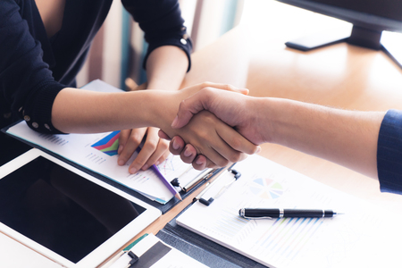 Business handshake between male and female business manの写真素材
