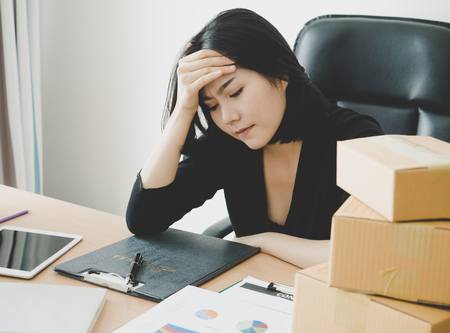 Female Office worker is exhausted with overworkedの写真素材