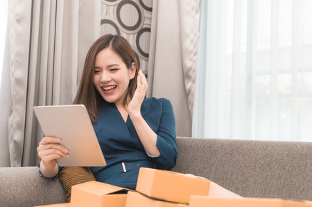 Business woman is happy with her online order for her online businessの写真素材