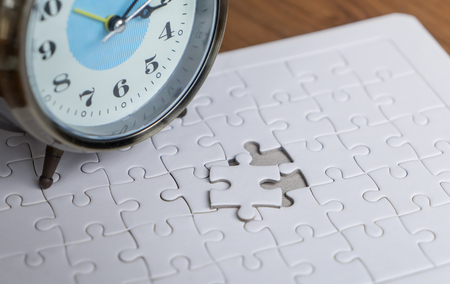 Alarm clock counting deadline with jogsaw for solution conceptの写真素材
