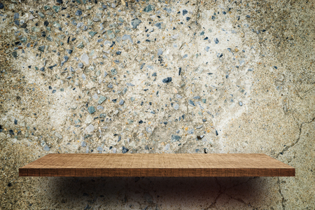 Blank wooden display shelf on grunge cement wallの写真素材