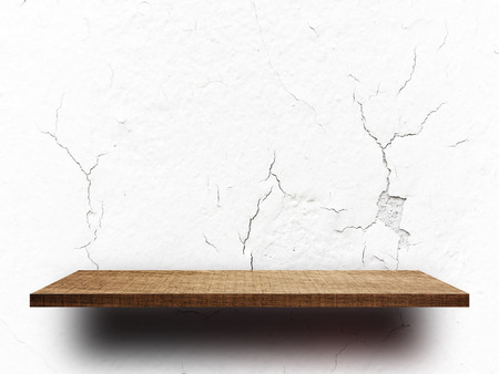 Empty wooden shelf on crack concrete wall for product displayの写真素材