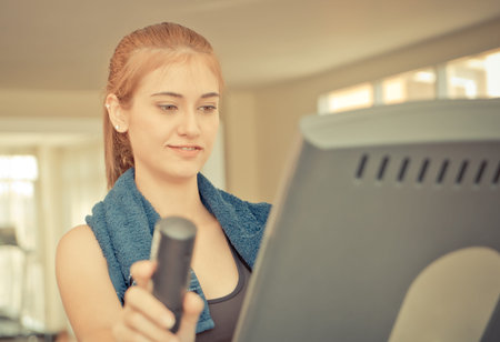 Asian woman portrait standing on fitness treadmill