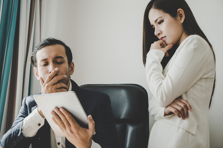 Business man is worrying about the report on tabletの写真素材