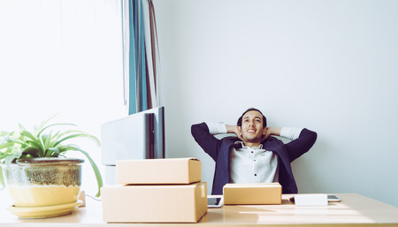 Business man is sitting relaxing on office deskの写真素材