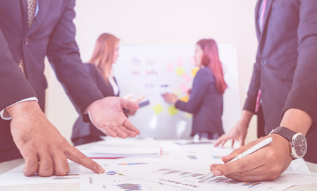 Hands pointing on data chart sheet for business meetingの写真素材