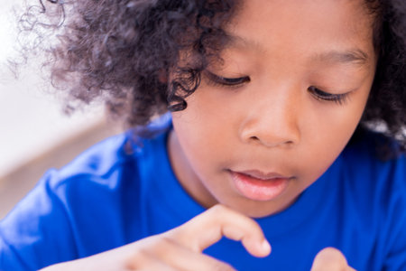 Portrait of little african kid is playing with something