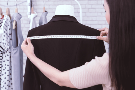 Japanese fashion designer is measuring jacket shoulderの写真素材