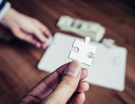 Hand holding the last right jigsaw for business competitive solution concept