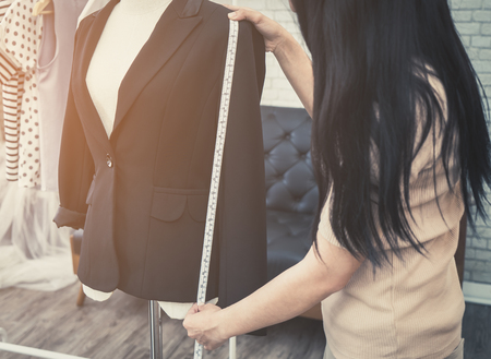 Fashion Designer hand is measuring jacket lengthの写真素材