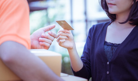 Woman is using credit card to pay for online delivery