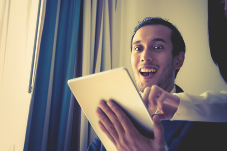 Business man is wow with what on tabletの写真素材