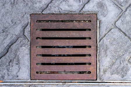 Old metal street water sewer cover top viewの写真素材