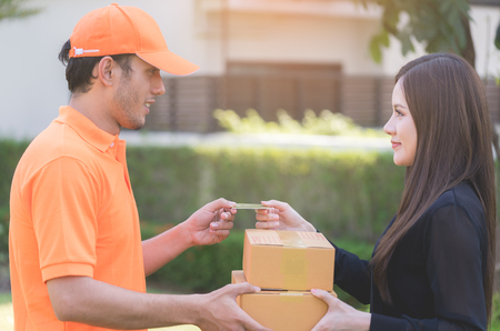 Woman is using credit card to pay for online deliveryの写真素材