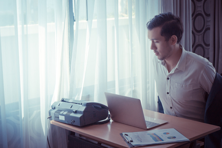 Business man is taking off shirt relaxing in hot dayの写真素材