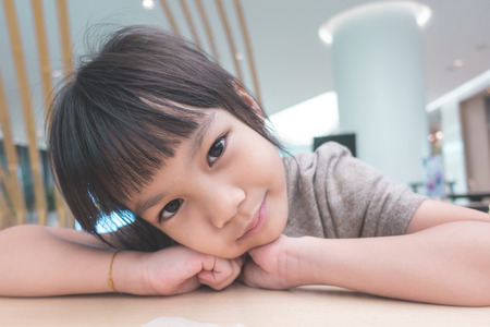 Little girl portrait sitting in cafeの写真素材