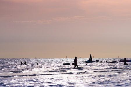 Golden sunset Beach with family silhouette shadowの写真素材