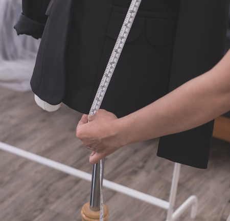 Fashion Designer hand is measuring jacket with measuring tapeの写真素材