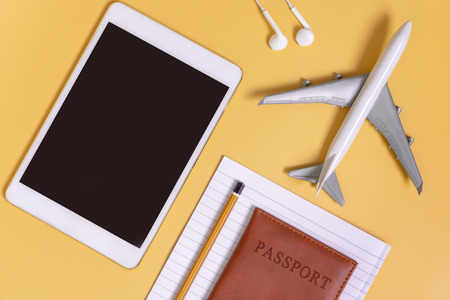 Travel gadgets flat lay yellow background for travel conceptの写真素材