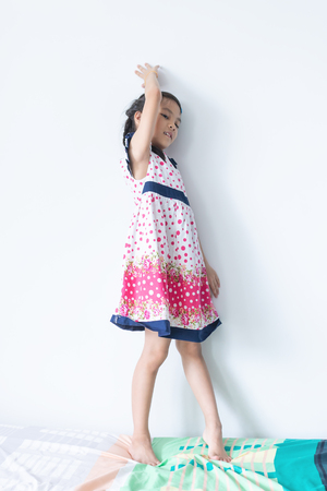 Little Asian girl portrait in sweet vintage dressの写真素材