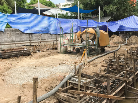 Starting pouring wet concrete in to a house foundation construction site