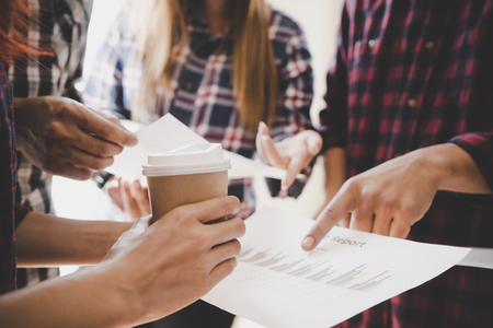 Hands pointing on data chart sheet for business meetingの写真素材