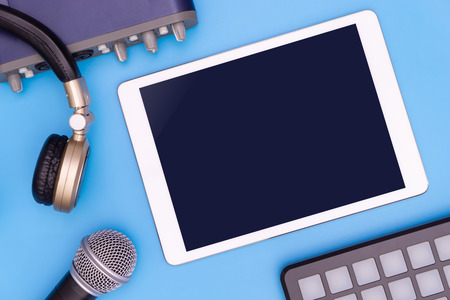 Blank tablet screen with music recording equipmentの写真素材