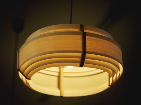 Orange ceiling lamp in dark room.の写真素材