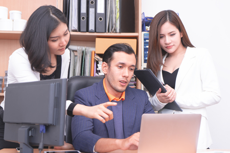 Female worker and male boss is brainstorming on computerの写真素材