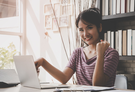 Smart Woman is working at home with computer success handの写真素材