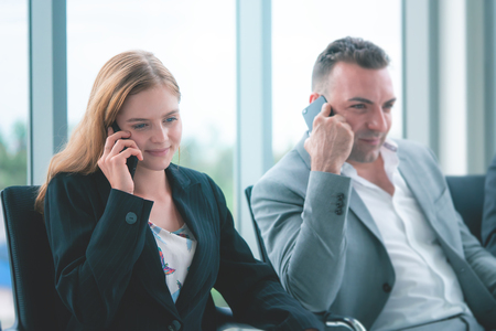 Business people are making call on their mobile phoneの写真素材