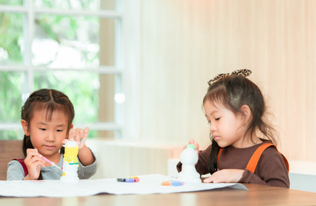 Asian girl is painting on paper in Art group