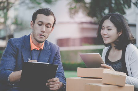 Online retailer is working outdoor shipping to customerの写真素材