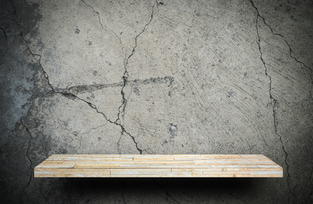 Blank rock stone display shelf on crack cement wallの写真素材